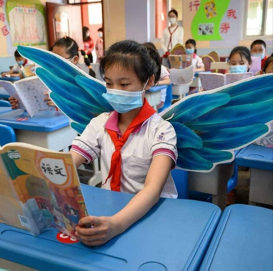 Na China, alunos usam “asa de um metro” para manter o distanciamento social.