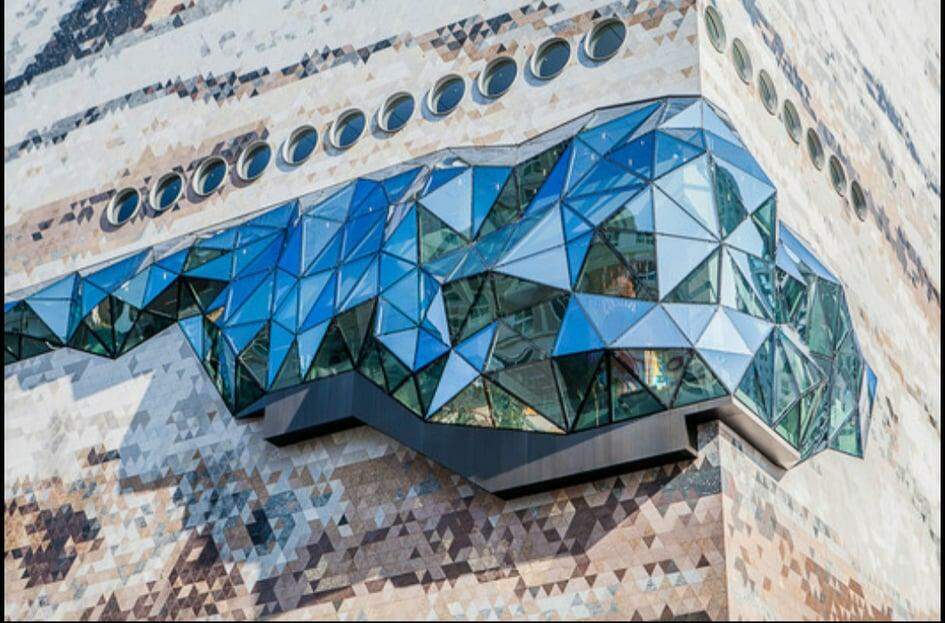 Loja sul-coreana ganha fachada com textura de pedra e mosaicos de vidro