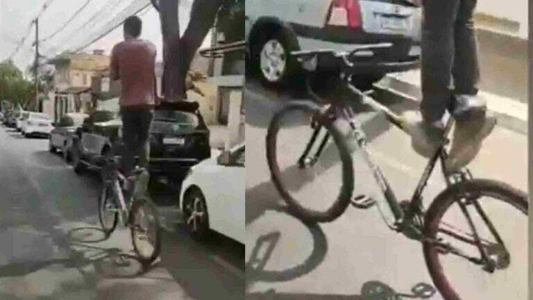 Homem trafega de pé em bicicleta